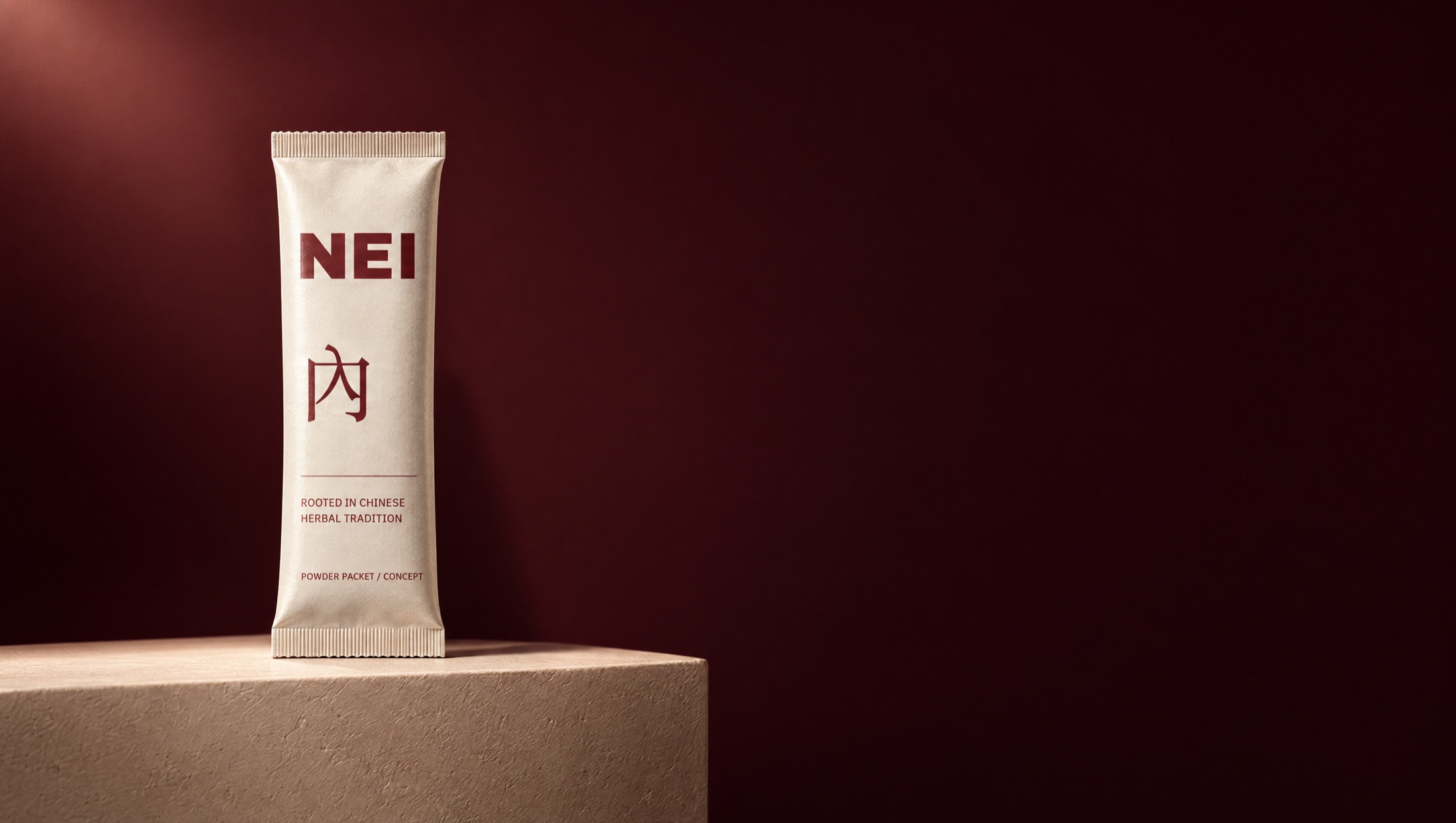 Concept photograph: a cream NEI powder packet with oxblood lettering stands on a plaster plinth against a deep oxblood wall